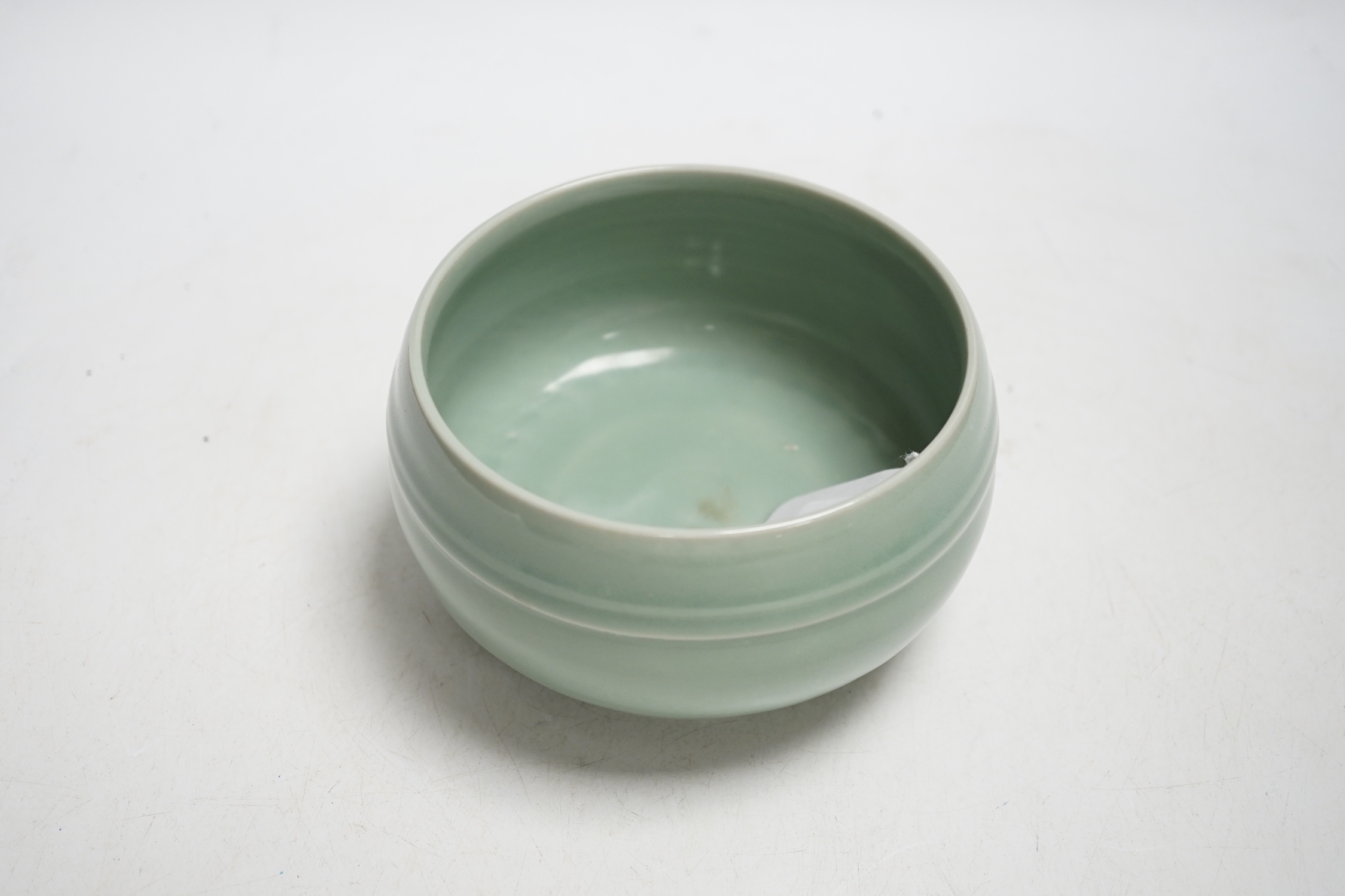 A Chinese celadon glazed pot, 8cm high